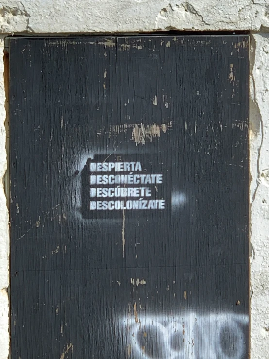 the sign is attached to a wood frame