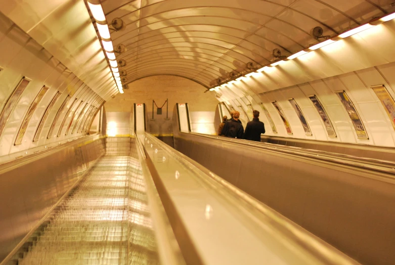 a man and a woman walking down an escalator