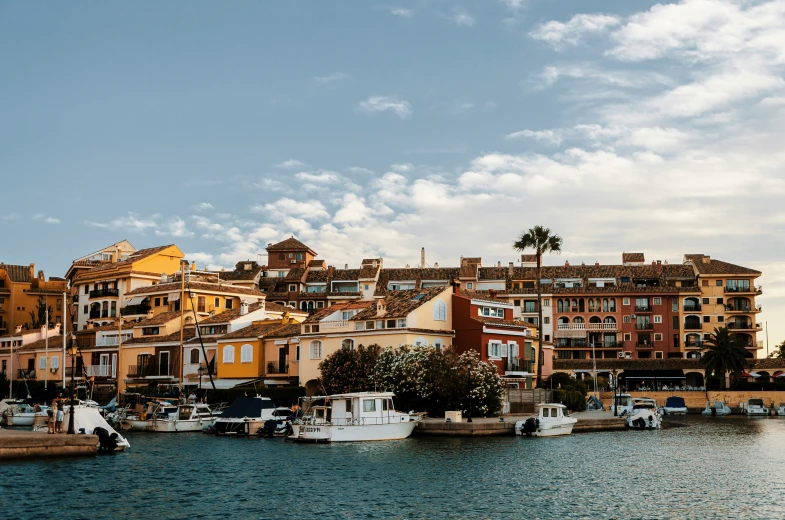 boats docked in a lake with buildings on the other side