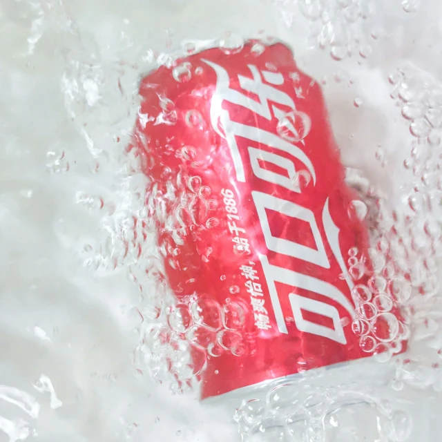 a red pepsi soda can sitting on top of a white table