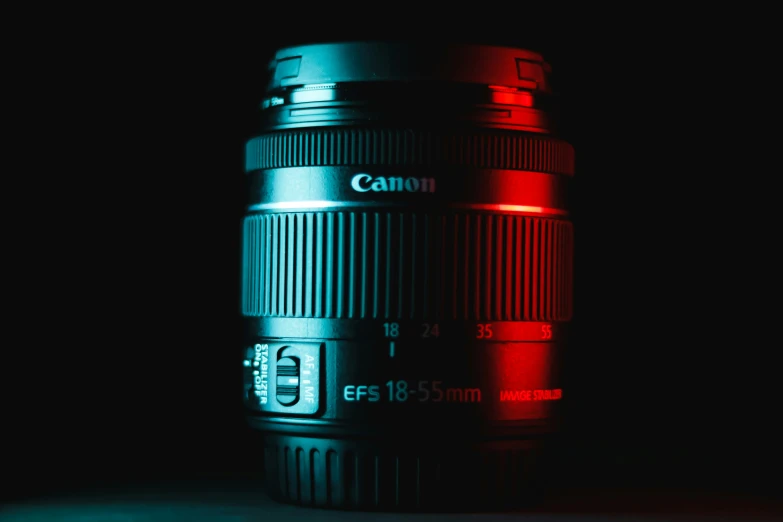 a camera lens with red and blue lights reflected in the lens