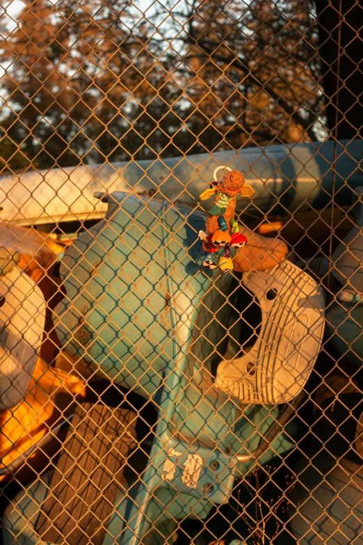 a close up of a skateboard and helmet behind a fence