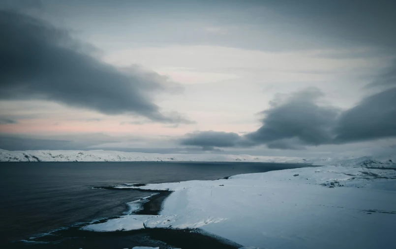 a couple of boats on a body of water covered in snow