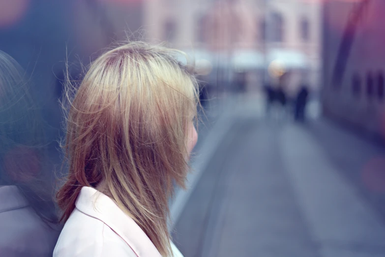 a woman is staring down an empty street