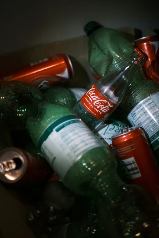 many open and empty soda bottles stacked up