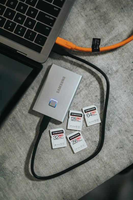 three batteries attached to a computer sitting on a table