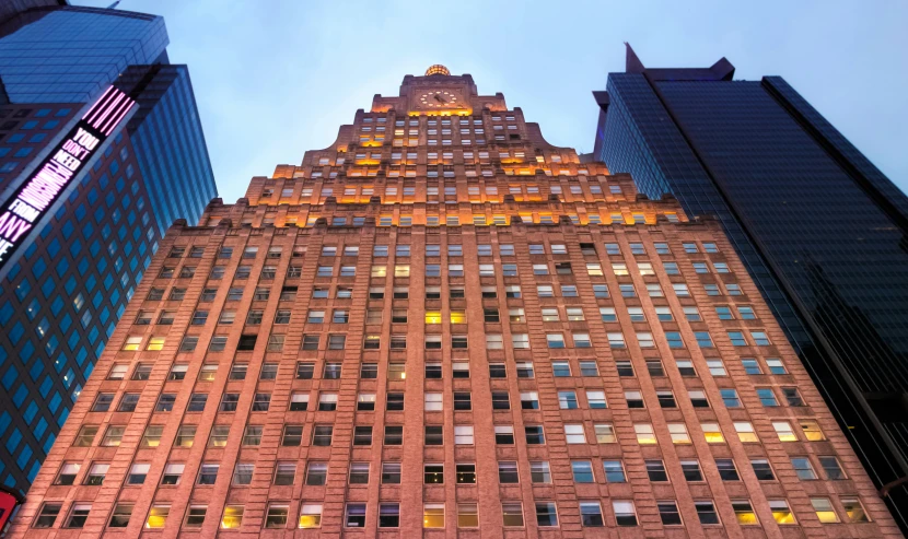 there is a tall building with several windows lit up