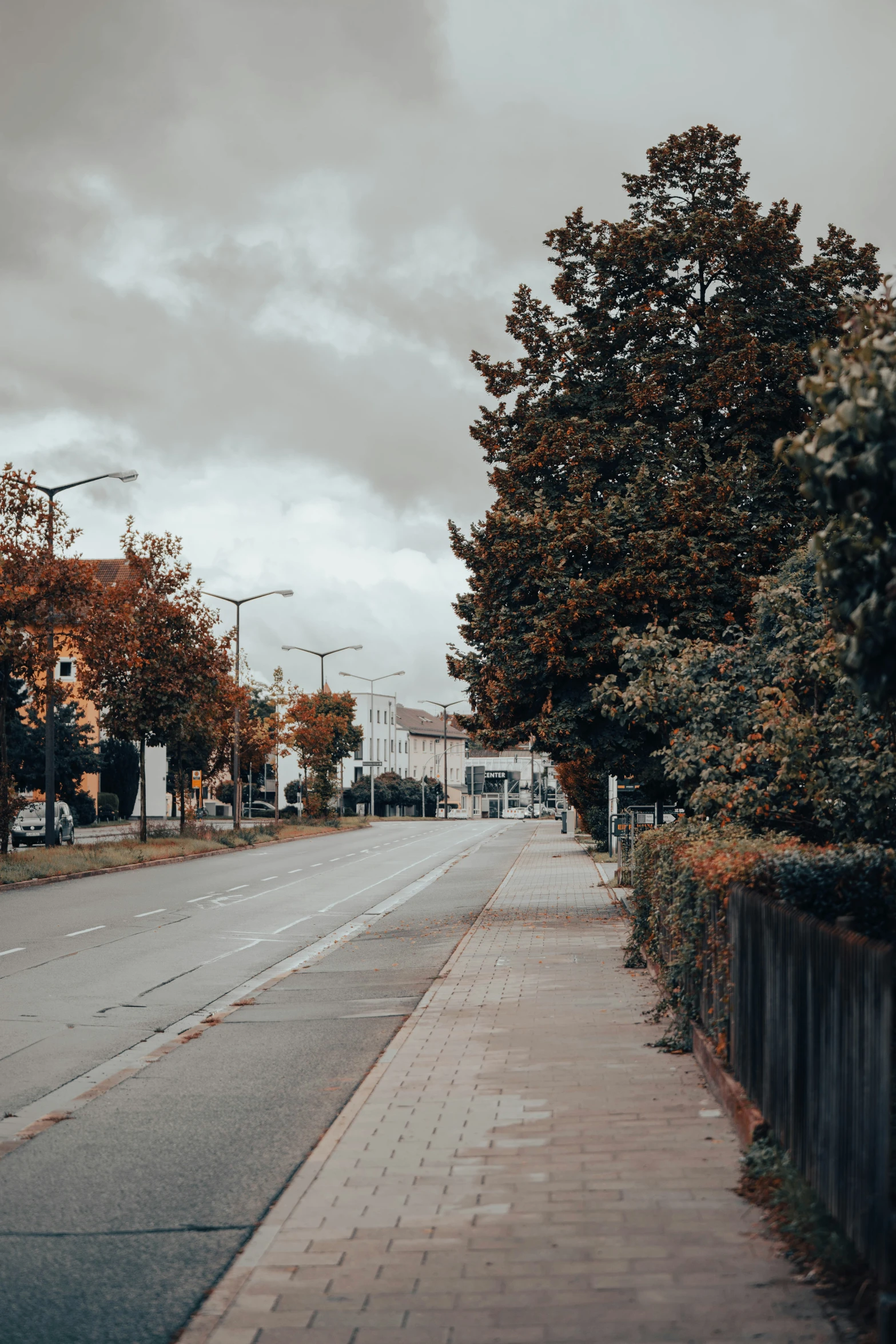 a street scene with a sidewalk and a streetlight