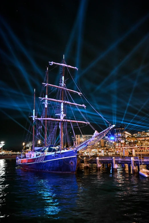 a large boat sailing by a large city