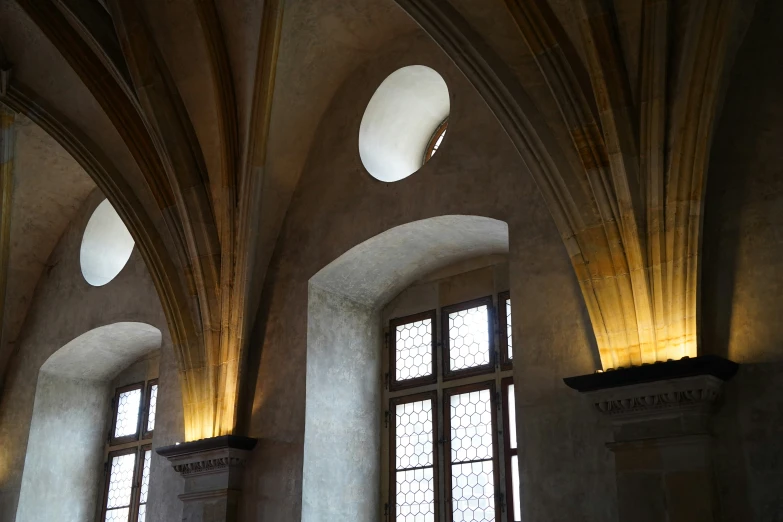 an empty building with three windows and two large columns