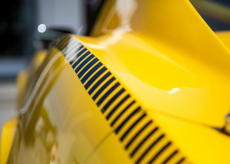 closeup of a shiny and modern yellow sports car