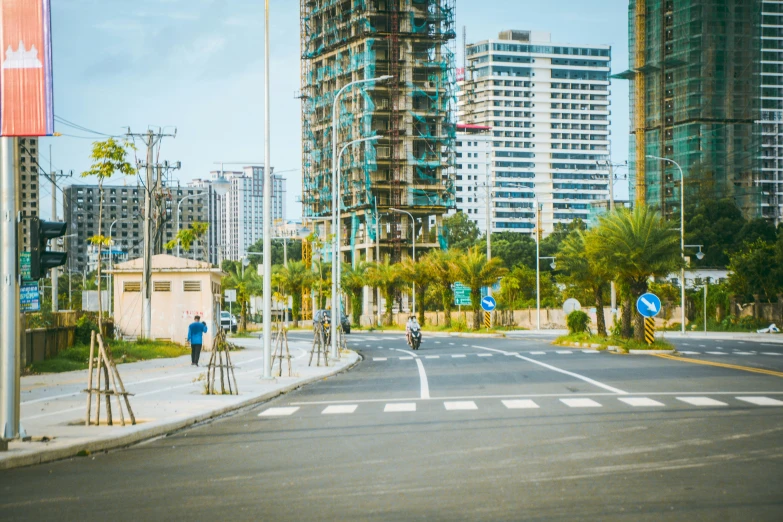 a street that has two people riding bikes