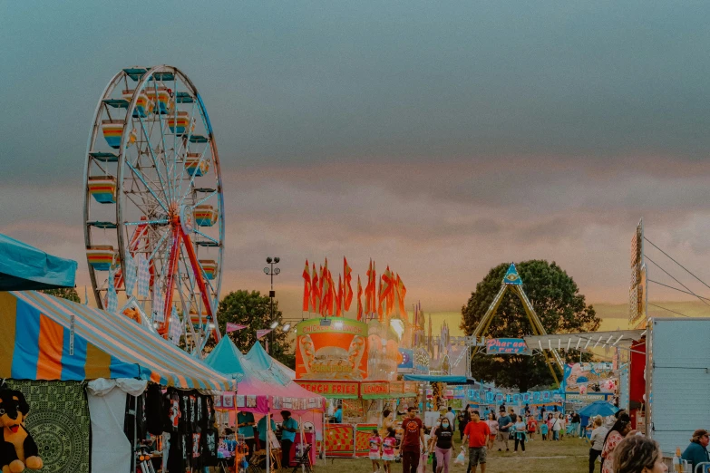 a carnival is full of people and rides