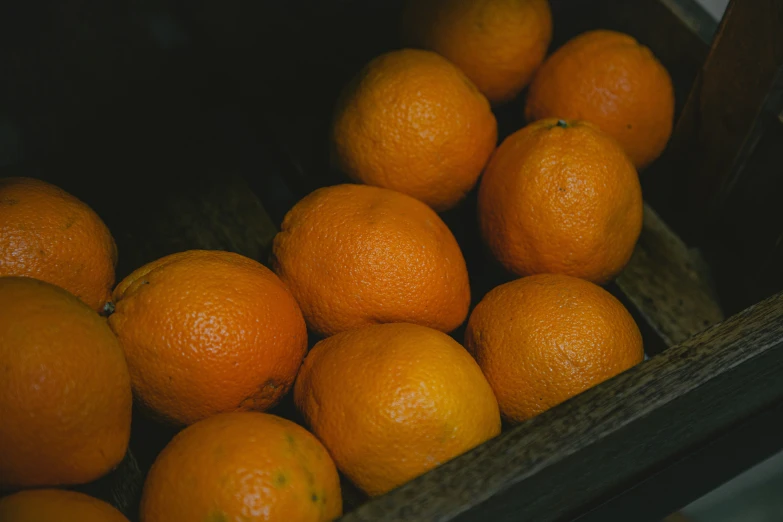 there is a basket of oranges stacked on top of each other