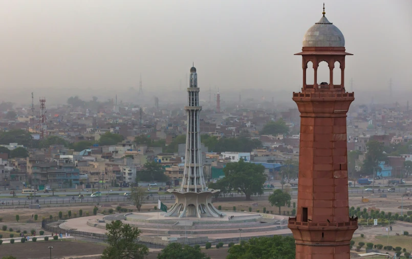 a very tall clock tower in the middle of a city