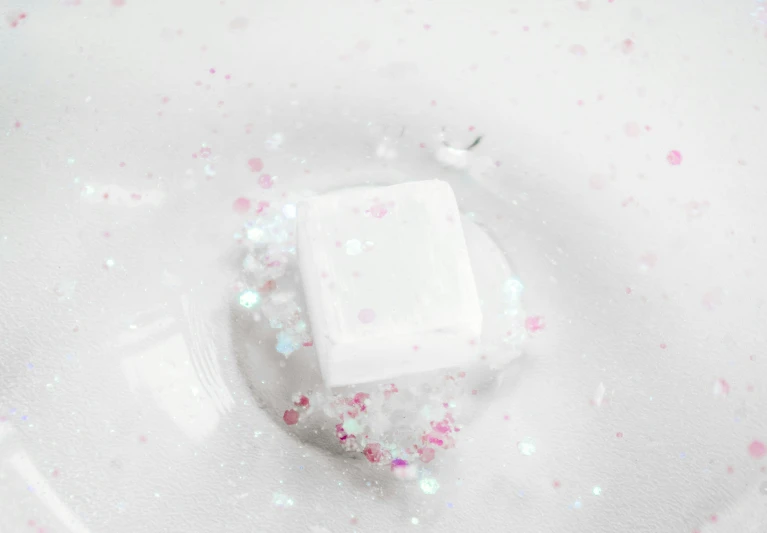 small white square with scattered confetti on it