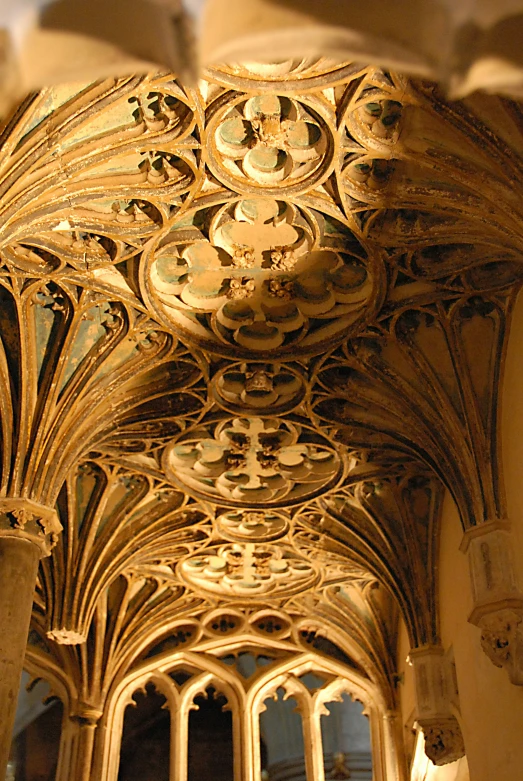 the ceiling inside a large cathedral looking up at the pews