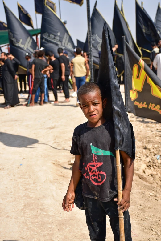 a boy carries a flag at an event