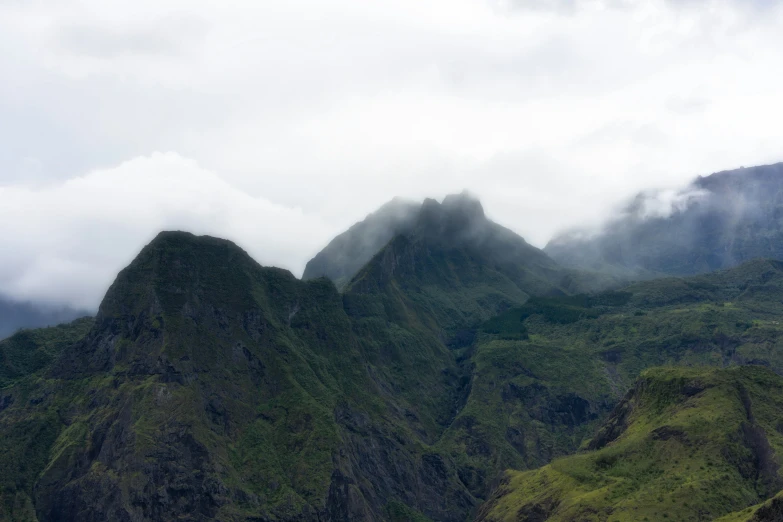 a view of a mountain with several steep mountains