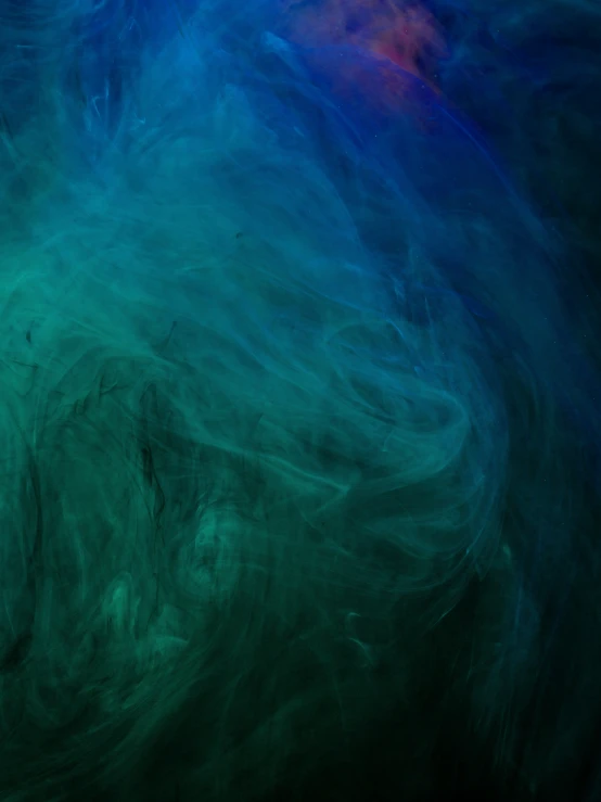 a multicolored swirl of liquid swirling over a black background