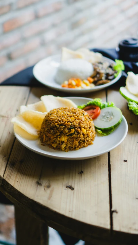 food on plates sitting on a wooden table