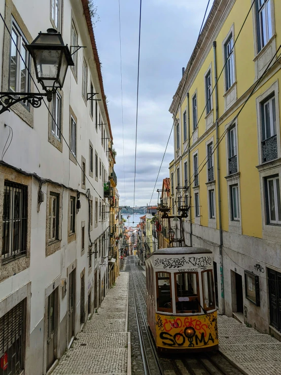 a trolley is going down a narrow street