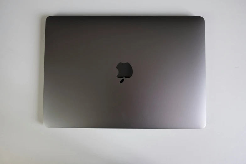 an apple laptop sitting on a desk top