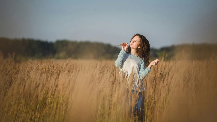 woman in a field looking up to the sky