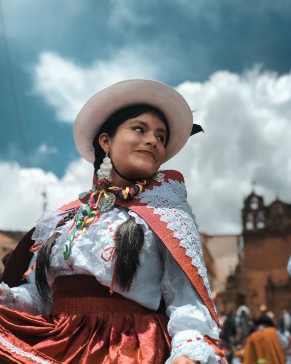 a mexican girl in colorful dress standing with her hand on her hip