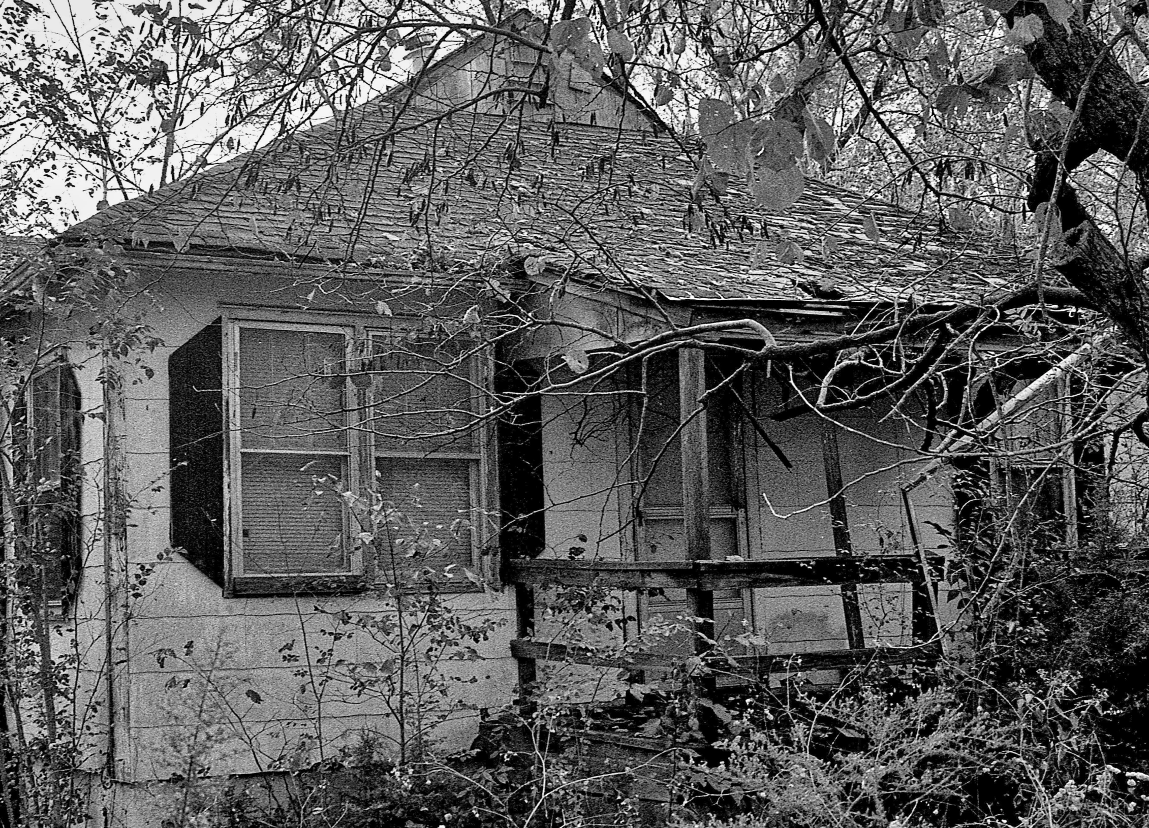 black and white pograph of a broken down home