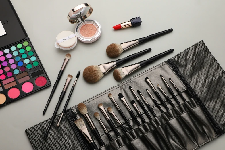 makeup and cosmetics are arranged neatly on a table