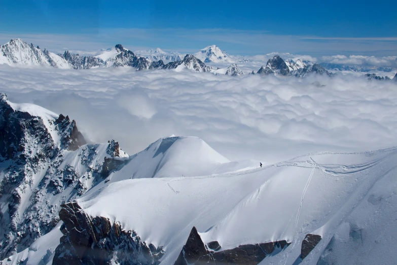 a man is skiing over the snowy mountains