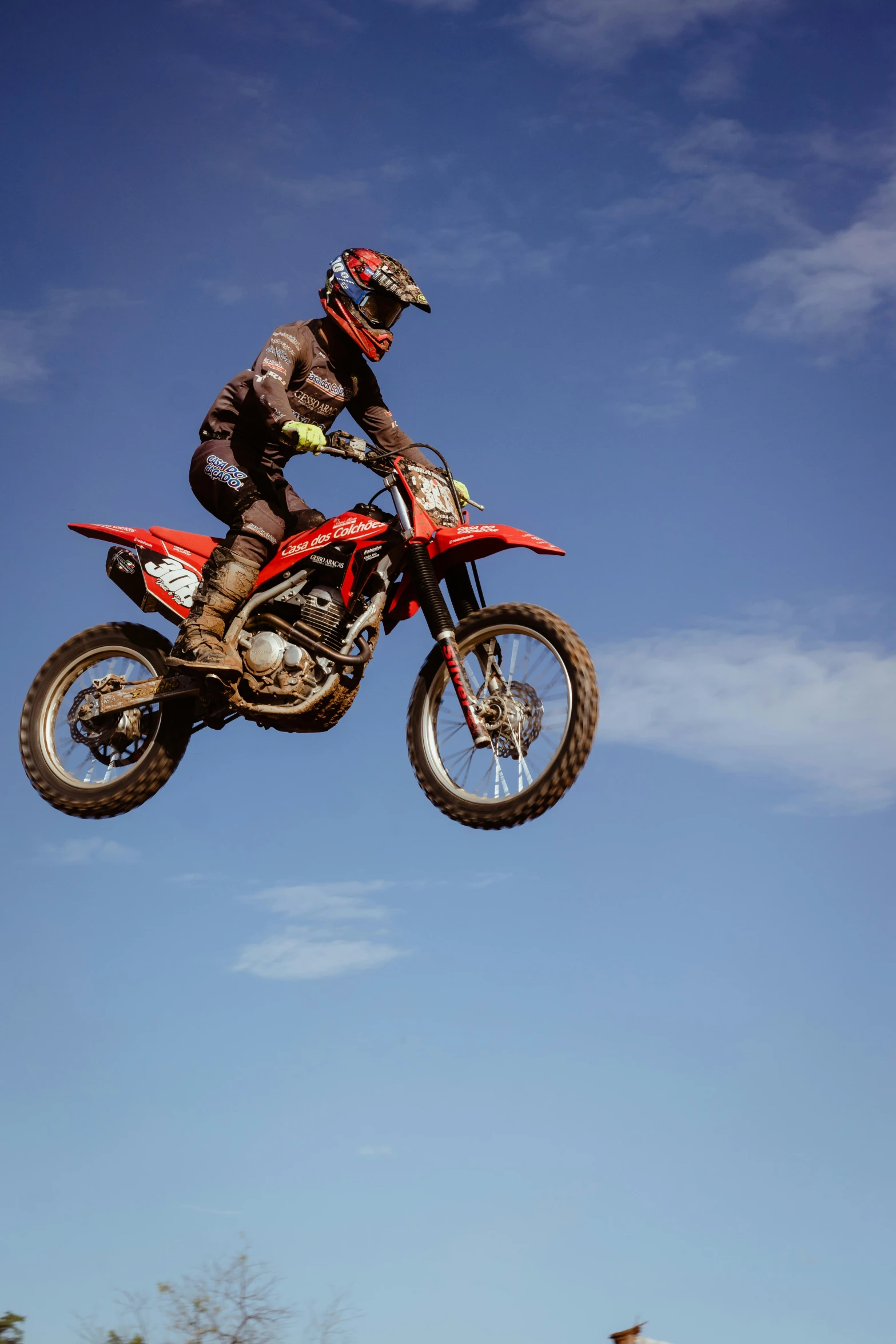 a man that is jumping his dirt bike in the air