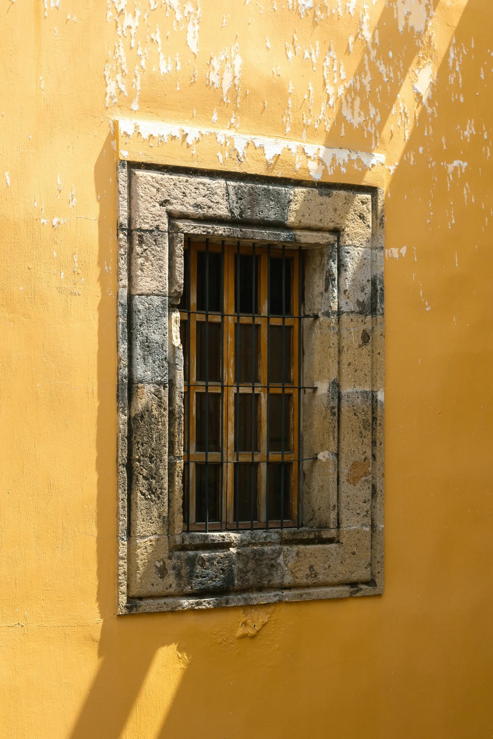 a window on the side of a building with bars