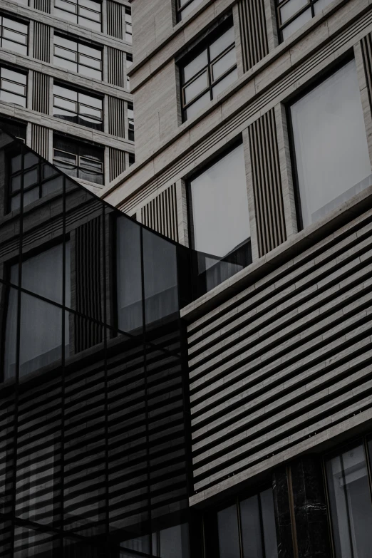 a tall building with lots of windows next to another building