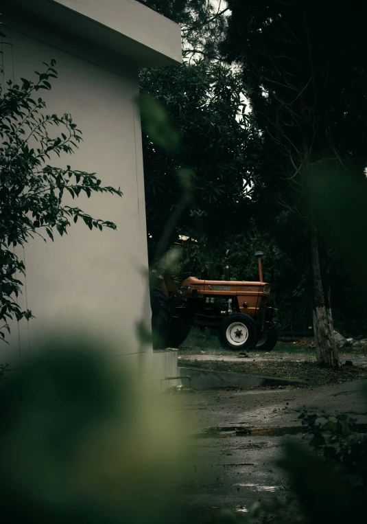 an old tractor on a dirty ground outside