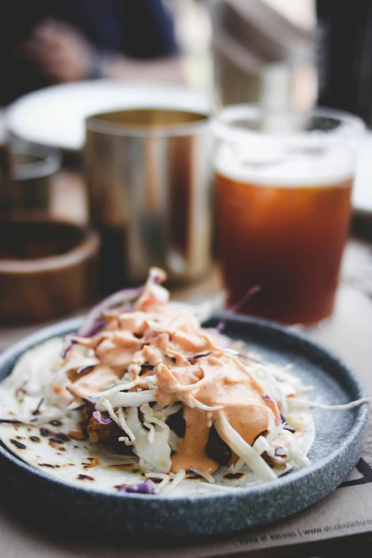 a plate topped with coleslaw on top of a wooden table