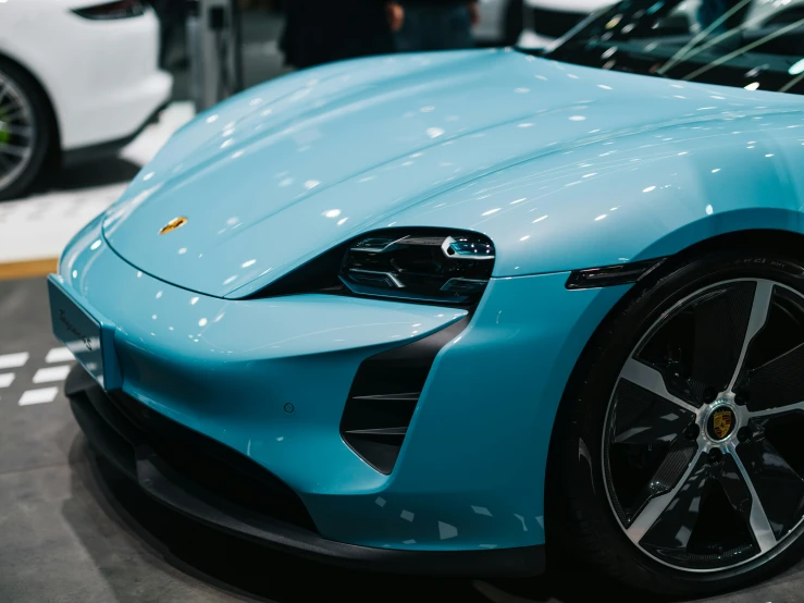 a light blue sport car in a showroom