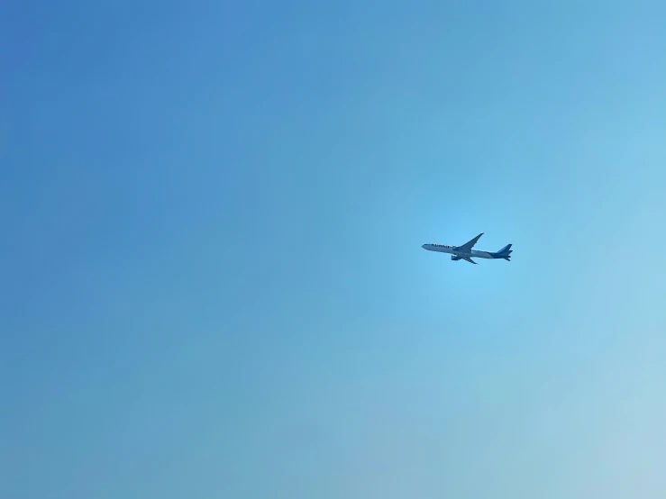 an airplane is in the sky and the sun shines on the bottom