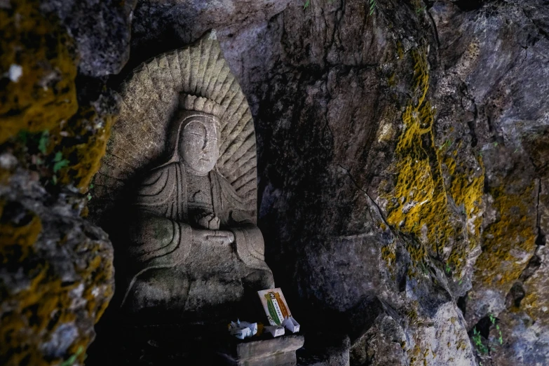 a statue sits in a cave at night