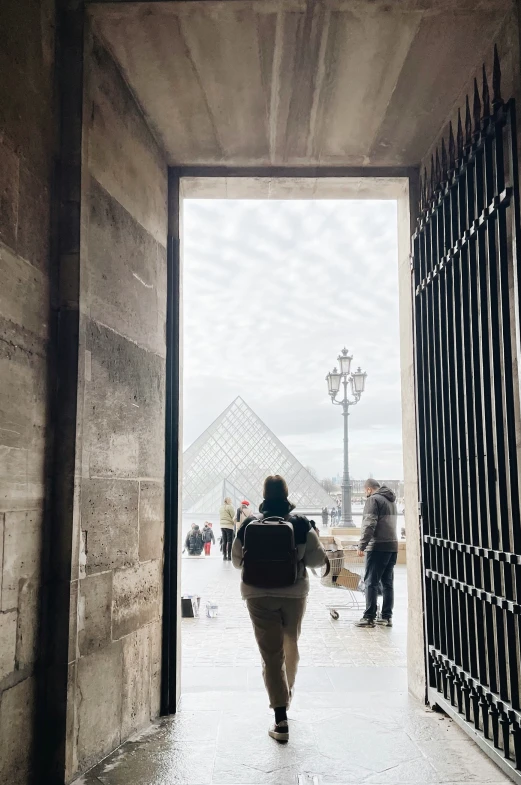 a woman that is walking into a building