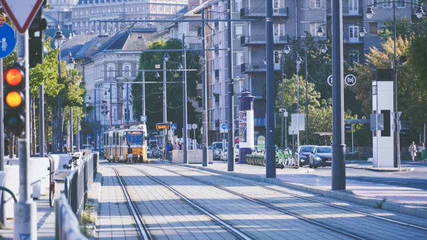 the tram has turned yellow to green in front of the traffic