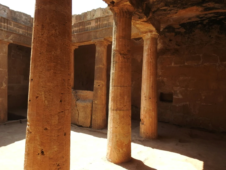 several tall pillars in an old stone building