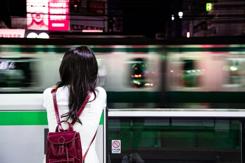 woman waiting at train station while the train pulls up