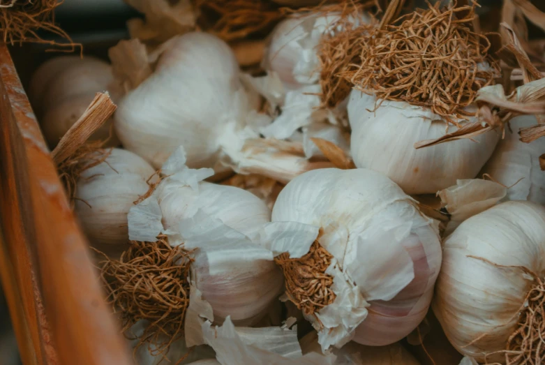 a wooden bowl filled with white onions