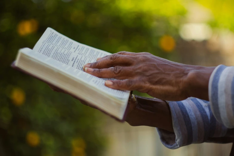 a man holding open a book with both hands