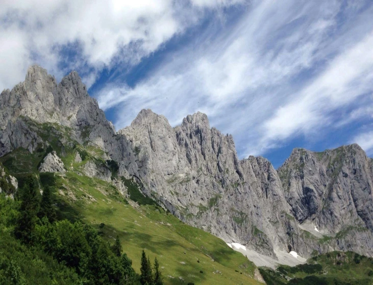 some tall mountains with trees on the top