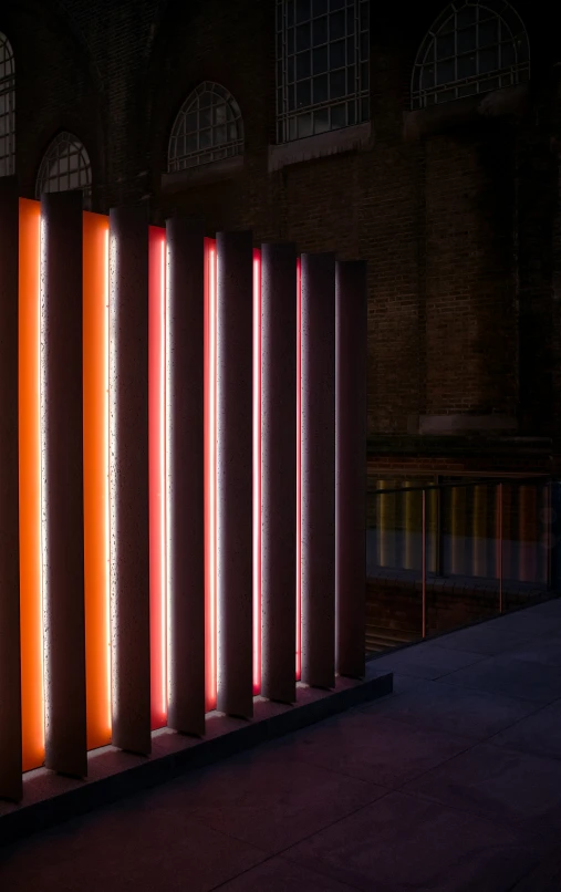 some neon lights that are standing in front of a building