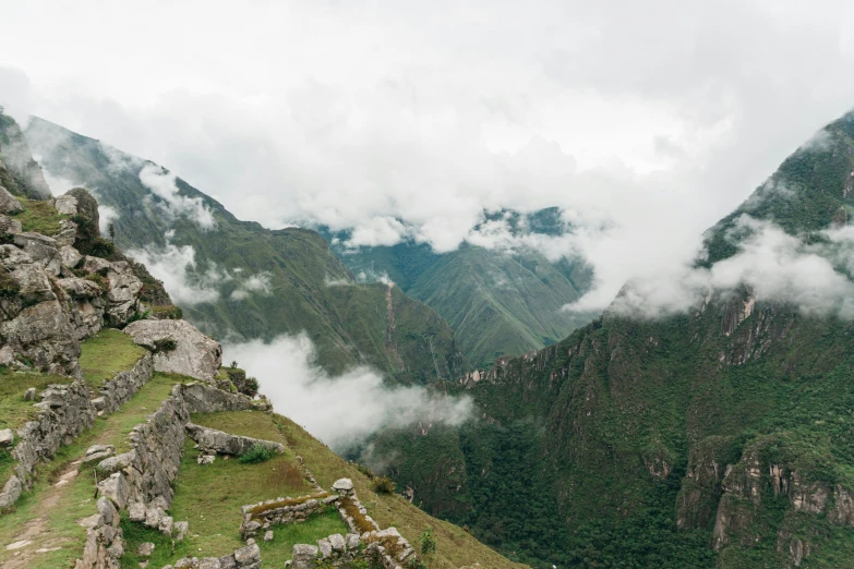 a view from a mountain with some grass and rocks