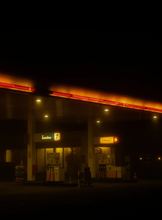 a gas station at night with red lights